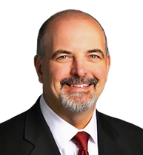 Professional headshot of a smiling man in a suit and tie, representing KVLR Capital's leadership team, emphasizing expertise in investment strategies and partnership opportunities.